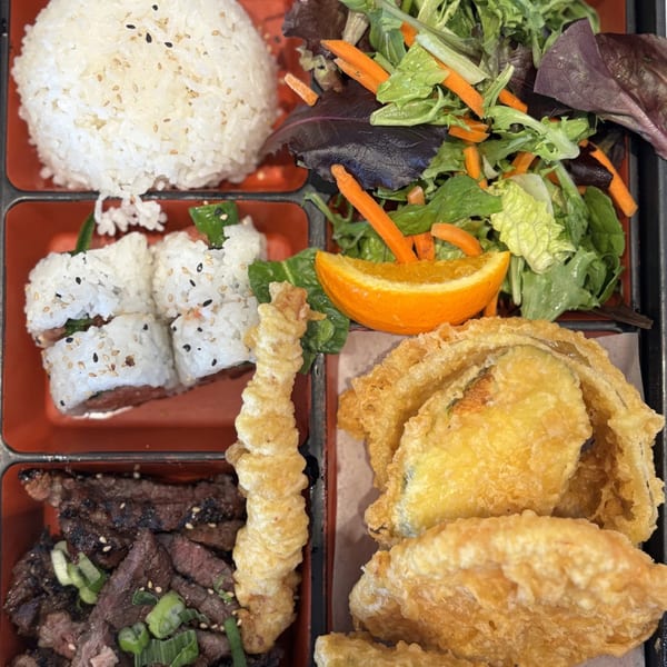 Mako Ramen bento box with rice, salad, sushi, tempura, and grilled beef.