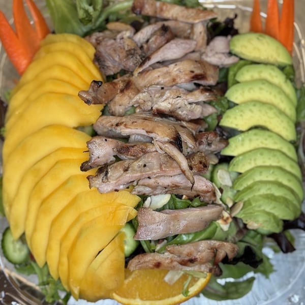 Mako Ramen's grilled chicken salad with sliced mango, avocado, and carrots.
